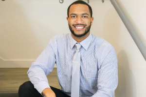 Davon Smiling at Camera with Blue Shirt and Blue Tie